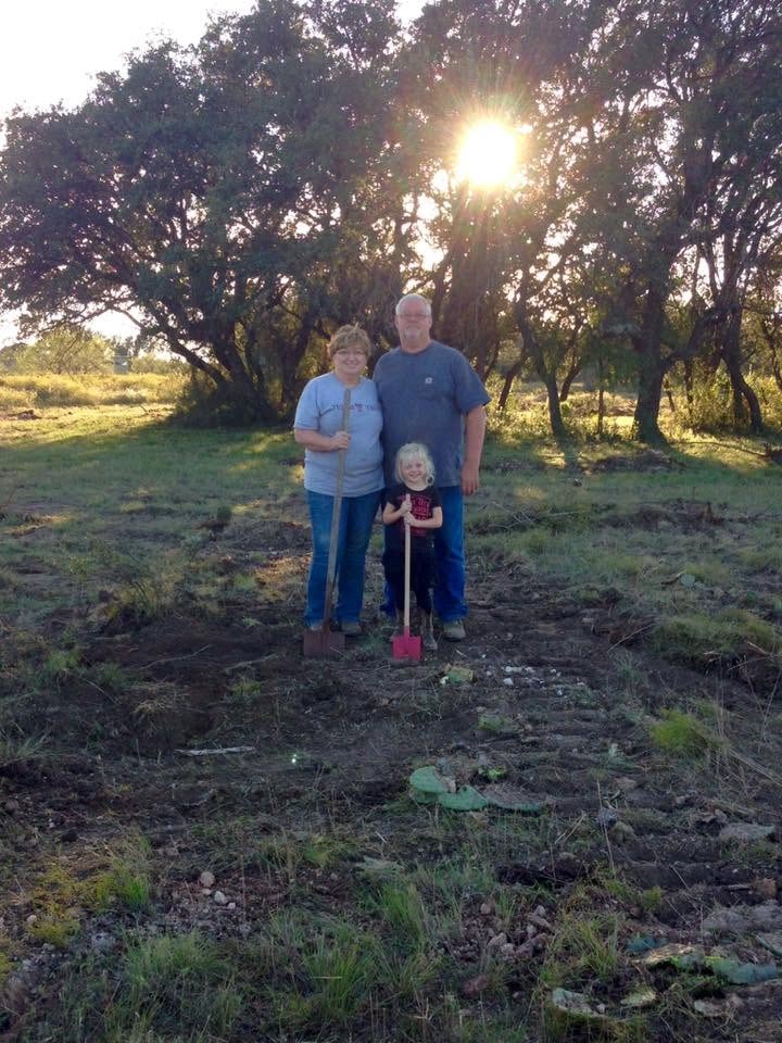 Family standing together at a Bar Spur Co job site at sunset